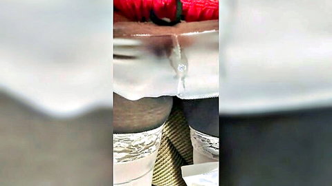 Dark-skinned babe's shaved pussy stretched by thick red dildo with white satin panties pulled aside and black lace stockings