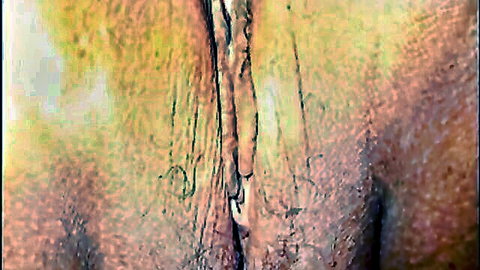 Extreme blurry close-up of hairy pink asshole with wrinkled yellow-toned skin folds