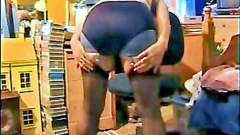 Curvy white woman bending over in tight black shorts, showing big ass