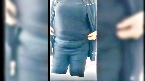 Turbaned Turkish woman in black outfit posing with hands on hips