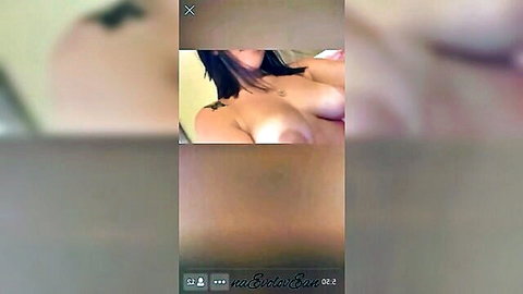 Asian beauty with big bare tits exposed smiling topless on bed