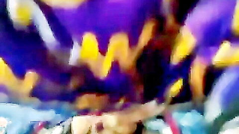 Blurry close-up of vibrant purple and yellow iris flowers blooming wildly