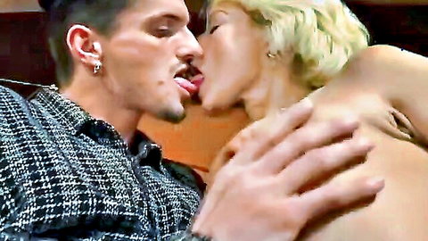 Muscular guy in shirt French kisses busty blonde mature woman while groping her bare tits passionately