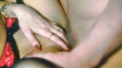 Woman's hand with red nails and gold jewelry strokes thick hairy erect cock closeup