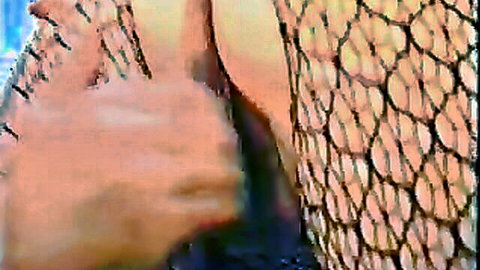 Hand pulls aside fishnet pantyhose exposing wet shaved pussy closeup