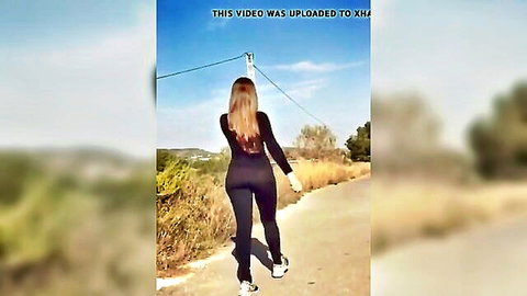 Curvy brunette in tight black pants walking outdoors, ass view from behind