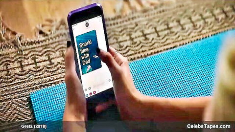 Hands gripping purple phone showing Snapchat time with Dad on blue yoga mat
