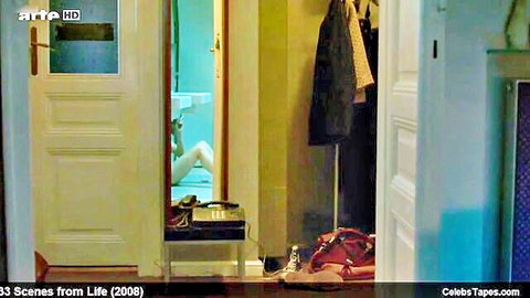Voyeur mirror reflection of woman's hairy pussy exposed on toilet with legs spread and panties down
