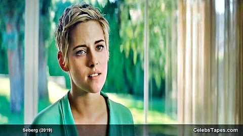 Kristen Stewart with short blonde hair pouting seductively in green top movie scene