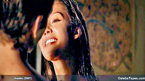 Wet Asian teen smiling seductively up at man in steamy shower closeup