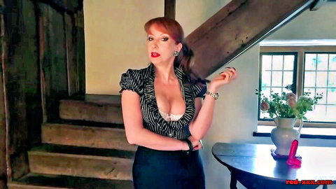 Curvy redhead MILF in deep cleavage blouse posing seductively by pink dildo on stairs