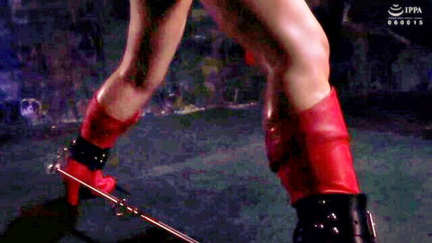 Bound legs in red thigh-high boots with chains, BDSM fetish pose