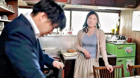 Japanese MILF housewife in cardigan and skirt with suited man in kitchen tease