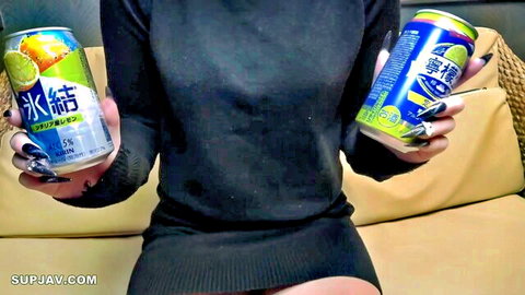Sexy Asian woman in tight black dress holding Pocari Sweat and Calpis cans teasing on couch