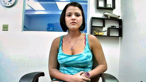 Victoria in sexy teal tank top, showing cleavage, solo pose