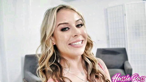 Summer Vixen blonde smiling in pink top, teasing closeup