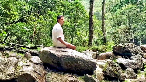 Devil Khloe redhead Latina in white top sitting on rock by jungle waterfall
