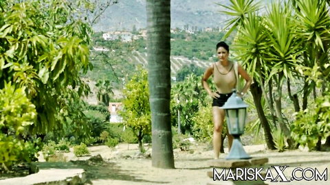 Sexy Asian babe in tiny crop top and shorts teasing in lush outdoor backyard garden