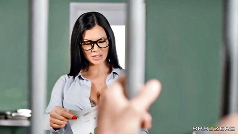 Brunette with glasses exposes deep cleavage behind jail bars as man's hand reaches in