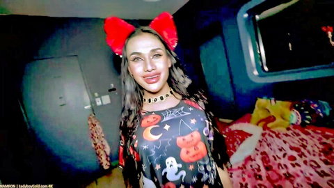 Sexy Asian Halloween catgirl with big tits sticking tongue out in bedroom