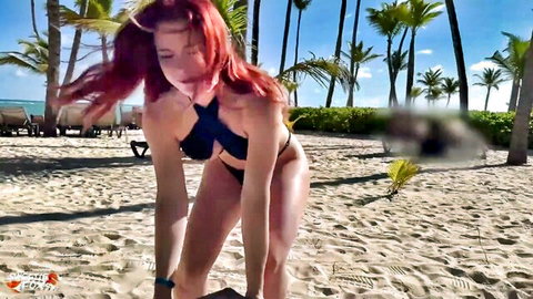 Sweetie Fox redhead in black bikini bending over on sunny beach