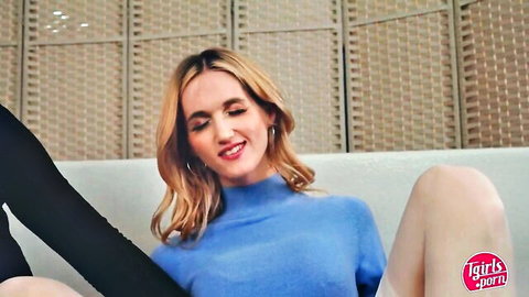 Blonde tgirl Rachael Belle in blue sweater and black pants, controlled by Aerie Rei TGirls XXX