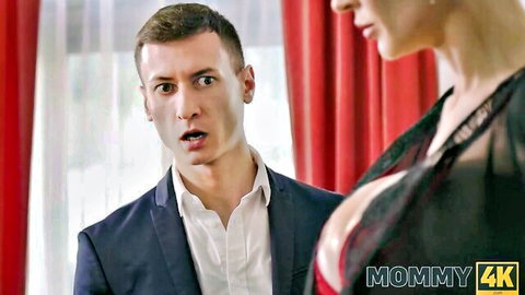 Busty blonde in black lace top teases suited man in Mommy4K scene