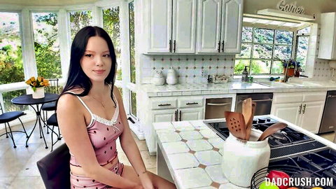 Brunette teen in tight pink camisole and shorts teases seductively in sunny kitchen