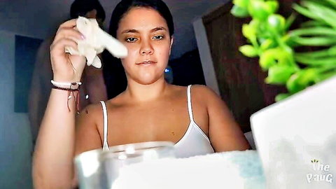 Latina MILF masseuse in thin white tank top holds cloth to face during anti-stress therapy