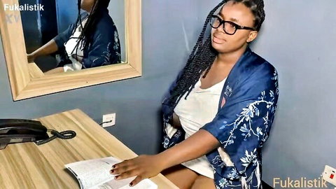 Sexy ebony CEO in blue floral robe teasing at office desk