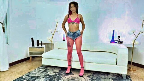Lunita Galactica posing in pink bikini top, tiny denim shorts, and pink stockings