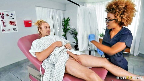 Ebony nurse in gloves teases patient's exposed cock in exam room