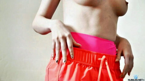 Busty blonde topless in pink bikini bottoms posing seductively