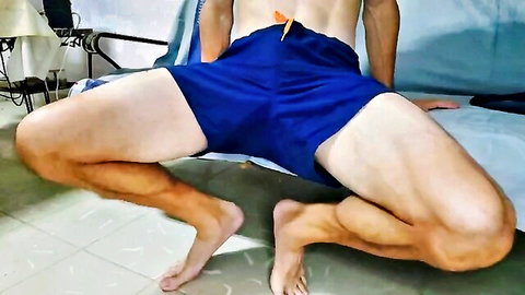 Hairy muscular guy squats low in tight blue speedo showing huge cock bulge solo tease