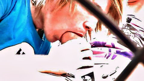 Blonde guy in blue shirt sucking thick veiny cock through metal bars in gay blowjob