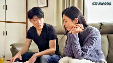 Ayaharu Natsume in tense JAV couch scene with man, emotional gaze