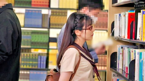 Japanese schoolgirl in sailor uniform browsing library bookshelves