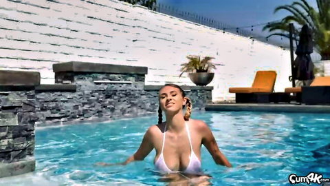 Curvy brunette with huge tits in skimpy white bikini teasing seductively in pool