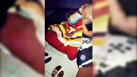 Blurry amateur Arab woman lounging on colorful bed sheets