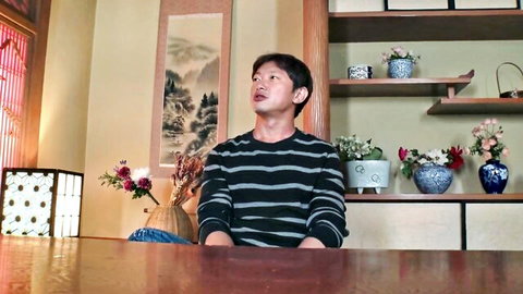 Young Japanese man in striped shirt, seductive gaze in JAV setup
