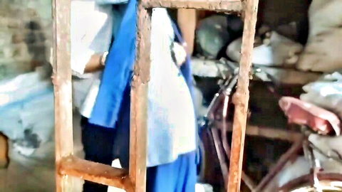 Desi Indian woman in blue salwar kameez stands in homemade video thumbnail