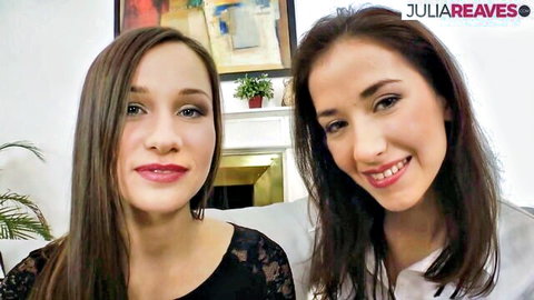 Two brunette lesbian babes in lace top and blouse smiling seductively
