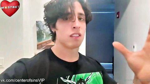 Brunette guy in black shirt gesturing and talking on webcam stream