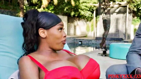 Busty ebony babe's massive tits spilling from red bikini top by pool