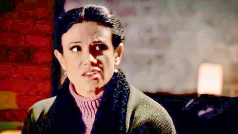 Penny Barber in The Storm, mature brunette with surprised expression in cozy sweater and jacket