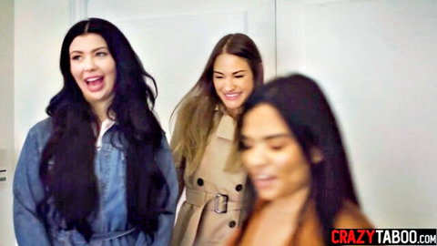 Three sexy brunettes in coats laughing naughtily in taboo apartment tease