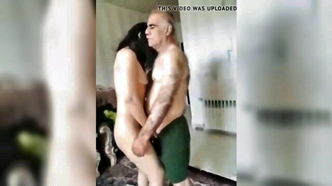 Iranian brunette nude woman in standing embrace with older man