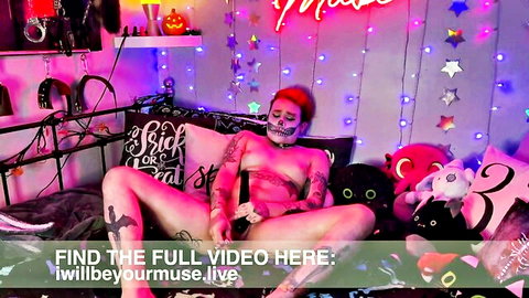 Iwillbeyourmuse redhead with sugar skull makeup nude spread legs holding controller
