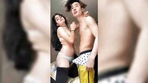 Very young slim couple embracing in white lingerie and shorts
