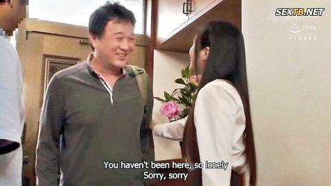 Asian niece in white blouse greets smiling uncle at door with flowers